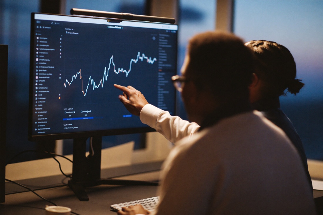 Two engineers reviewing a threat dashboard