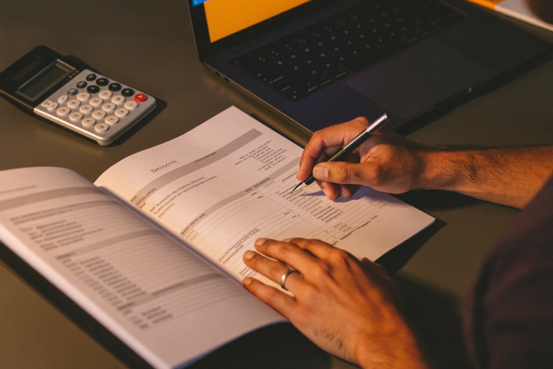 Hands reviewing a printed financial model